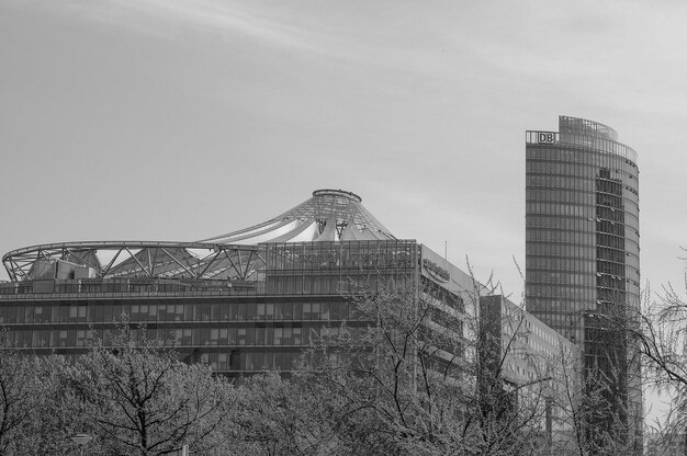A grayscale image of the european parliament building with binary code overlayed semi-transparantly on top to represent cryptography and the EU laws. Style to be serious and professional.