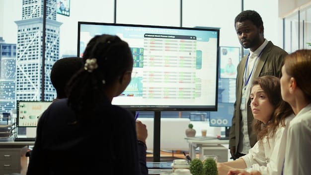 A diverse group of people in a startup-like office setting collaborating around a large touch screen displaying financial data and graphs, showcasing teamwork and innovation.
