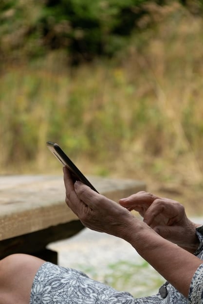 Close-up of a smartphone screen displaying a mobile banking app in Portuguese in a rural setting, symbolizing the challenges and opportunities of digital financial inclusion in remote areas of Portugal.