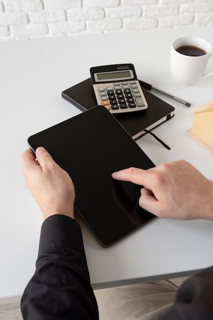 A hand holding a calculator above a table covered in financial documents such as balance sheets and credit applications. The scene conveys financial planning, loan management, and making informed financial decisions.