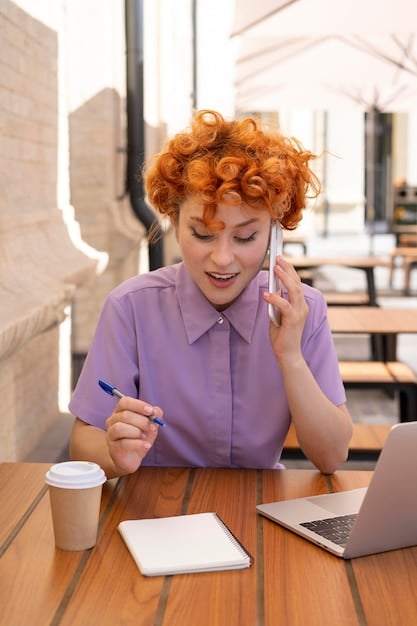 A person on the phone negotiating terms with a service provider, with a pen and notebook in hand, and a confident expression on their face.