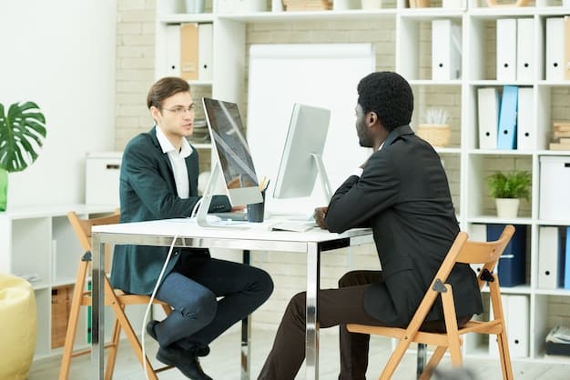 A professional sitting across a desk from their manager, having a serious but positive conversation about career advancement and compensation. Both individuals are engaged and respectful.
