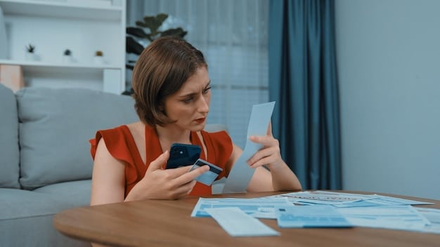 A person using a mobile app to track their credit card spending. The app shows a graph of expenses and budget alerts.